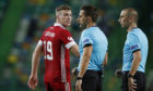 Aberdeen's Lewis Ferguson talks to the referee during the Sporting CP game