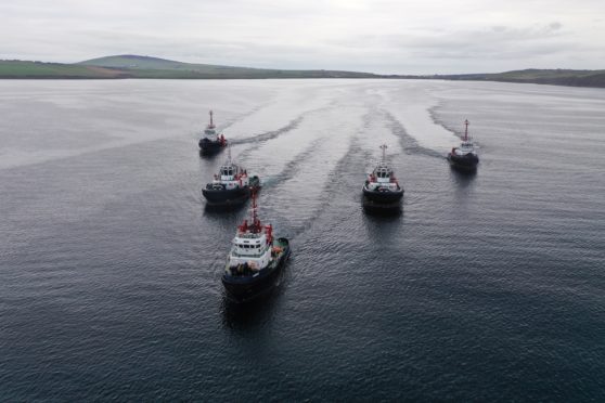 The two new tugs arrive in Scapa Flow, escorted by the three currently in service