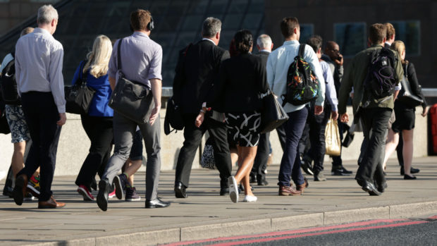City workers walking along London Bridge.