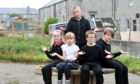 Pupils saddened by repeated vandalism of their secret garden. L-R: Lexi, Elina, AJ, Kasper and Simon, at the back. 
Picture by Jim Irvine.