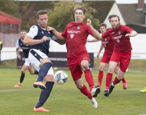 Dundee's Lee Ashcroft (L) and Colin Williamson of Brora in Betfred Cup action.