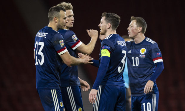 Scotland skipper Andy Robertson congratulates Aberdeen's Andy Considine, left, at full-time after his cap against Slovakia at Hampden.