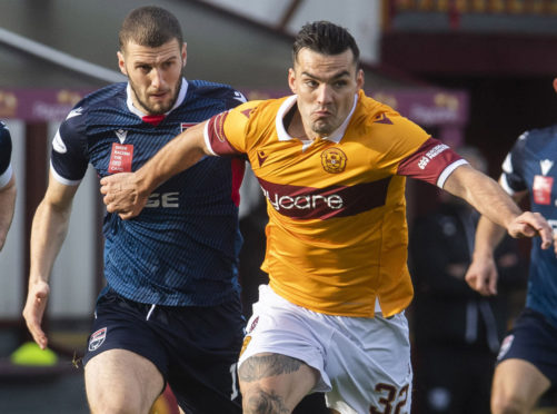 Motherwell striker Tony Watt gets away from Alex Iacovitti.