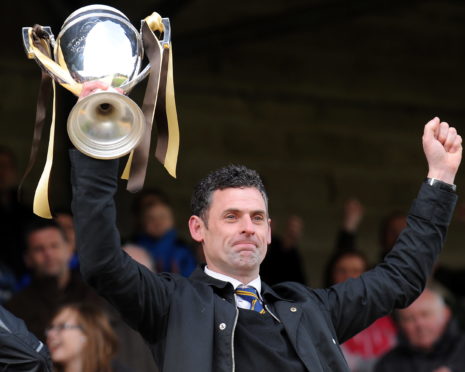 Charlie Rowley holds aloft the Highland League title in 2012.