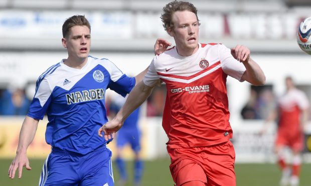 Nairn's Alan Pollock chases Brora's Ally MacDonald during the 2016 Highland League Cup final