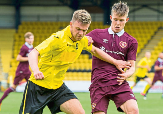 Josh Peters, left, playing for Livingston.