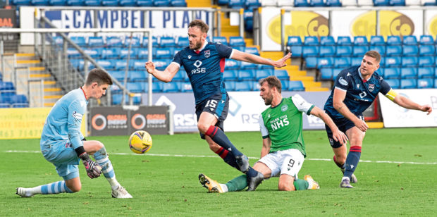 Ross County goalkeeper Ross Doohan denies Christian Doidge of Hibs.