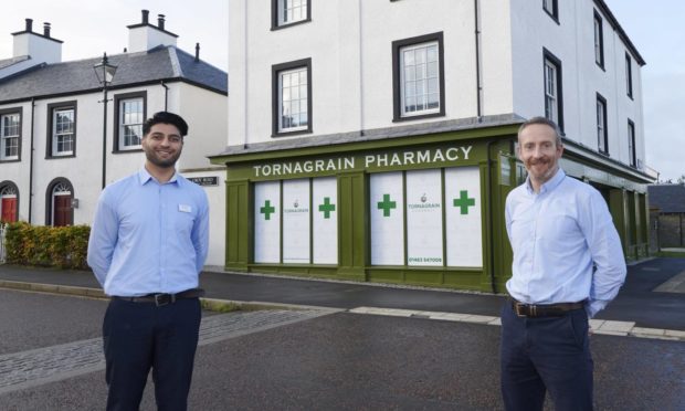 Tahir Rashid (l) and James Higgins (r) outside the new pharmacy in Tornagrain.
