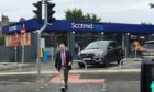 MSP David Stewart using the newly installed puffin crossing on the A82 on Glenurquhart Road at Smith Avenue, near the Scotmid store.