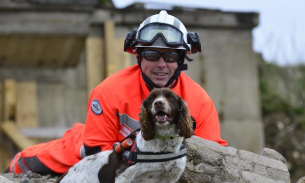 Diesel the dog, pictured with handler Gary Carroll, has picked up a 2020 Hero Pet award.