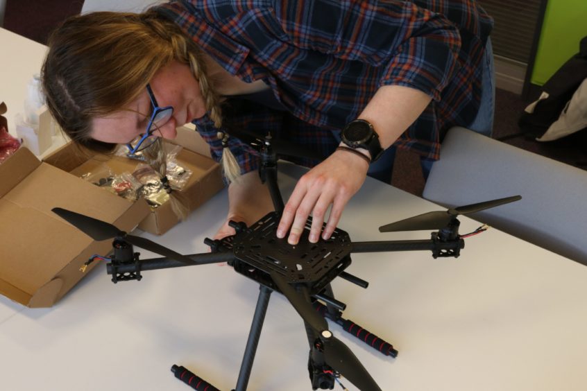 Sophie Barrack pictured alongside the drone she built.