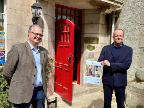 Knockomie Inn owner Gavin Ellis (left) and Stewart Marshall, of Johnstons of Elgin, at the Forres Inn with one of the prototype posters.