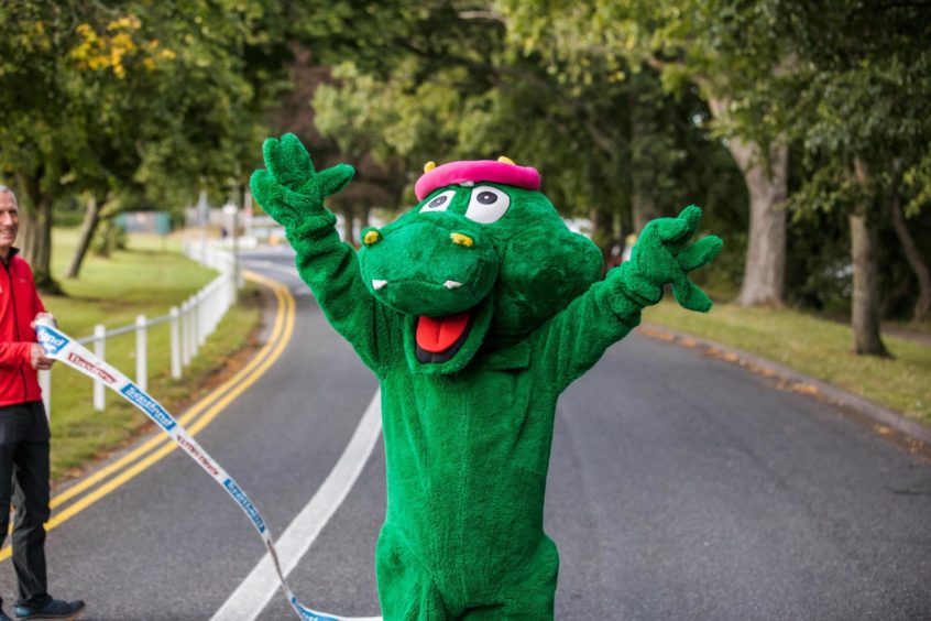 A Loch Ness Marathon runner dressed up as Nessie