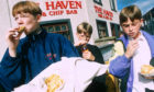 A group of young lads enjoying deep-fried Mars Bars from The Haven Fish and Chip Bar in 1999.
