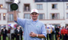 Scotland's Paul Lawrie holds the Claret Jug aloft after winning the 1999 Open Championship at Carnoustie, Scotland, after a play-off with Justin Leonard and Jean Van De Velde.