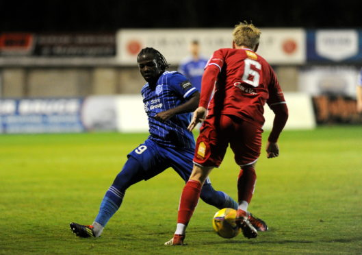 Peterhead's Isaac Layne and Brechin's Jonathan Page.
Picture by Darrell Benns.