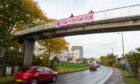 The banner was attached to a footbridge over the A96 Aberdeen to Inverness road in Elgin. Picture by Jason Hedges.