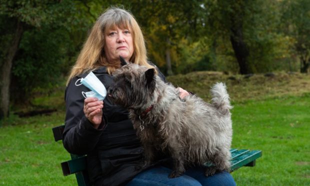 Linda Harper is highlighting the dangers to animals of discarded disposable face masks after her cairn terrier, Malcolm, ate one. Pictures by Jason Hedges.