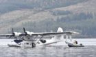 A seaplane is removed from Loch Ness by crane.
Pictures by Jason Hedges.