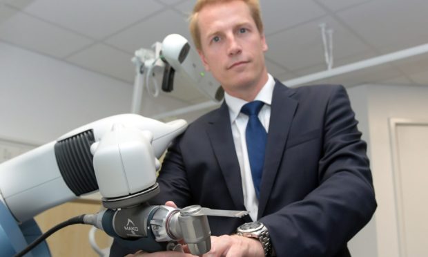 Consultant orthopaedic surgeon Martin Mitchell demonstrating the Stryker Mako at BMI Albyn Hospital.