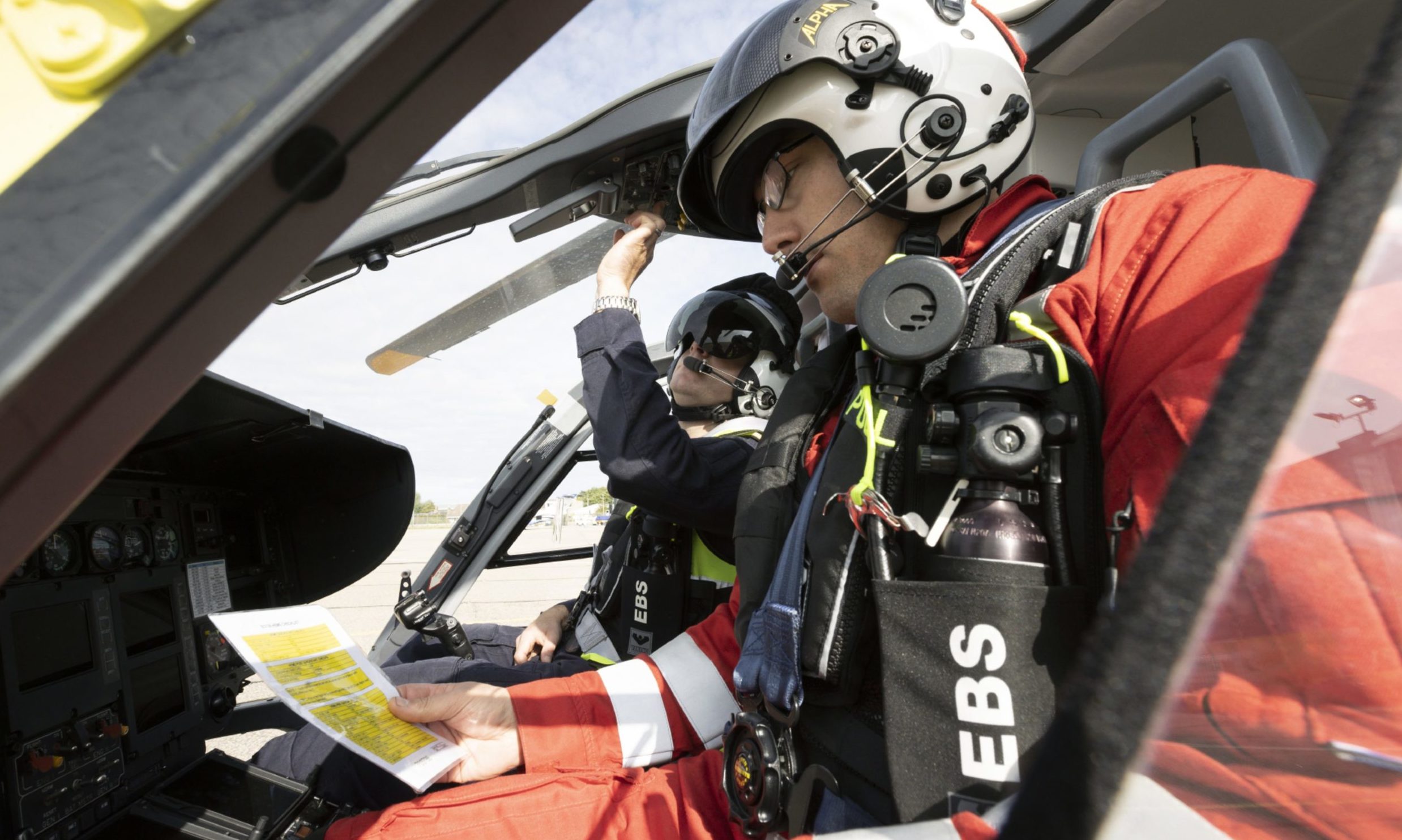 Helimed 79 pilot Captain Pete Winn and lead paramedic Ewan Littlejohn perform ground checks as Scaas Helimed 79 powers up at Aberdeen Airport.