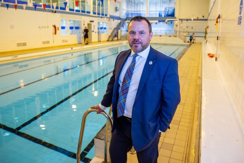 The Dingwall Leisure Centre chief executive, Steve Walsh, standing beside the centre's swimming pool.