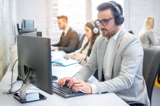 A male technical support dispatcher in call centre.