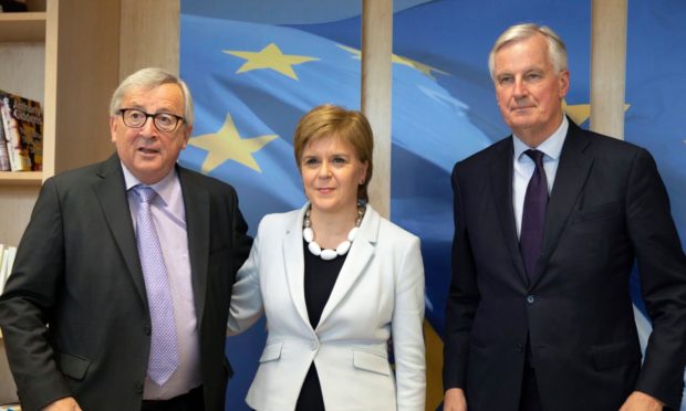 Scotland's First Minister Nicola Sturgeon poses with European Commission President Jean-Claude Juncker, left, and European Union chief Brexit negotiator Michel Barnier