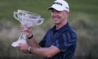 Martin Laird holds the trophy after winning the Shriners Hospitals for Children Open golf tournament in Las Vegas.
