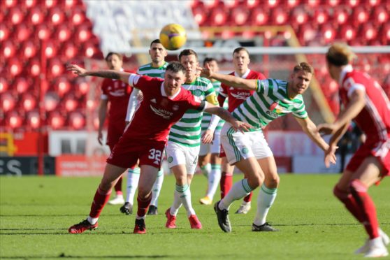 Aberdeen forward Ryan Edmondson (32) and Kristoffer Ajer (35) of Celtic challenge for the ball.