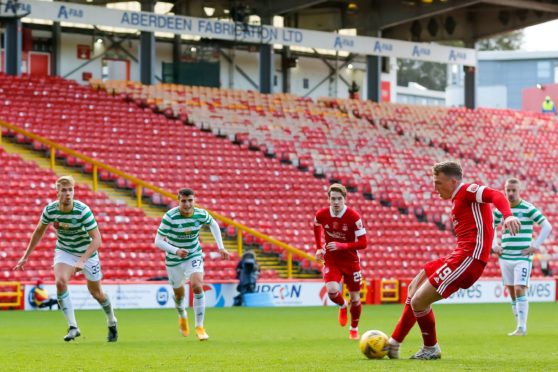 Aberdeen midfielder Lewis Ferguson scores to make it 3-3 in the game against Celtic.