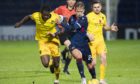 Ross County's Harry Paton holds off Marvin Bartley.