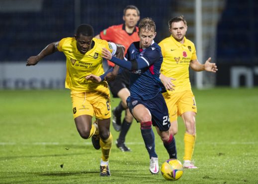 Ross County's Harry Paton holds off Marvin Bartley.