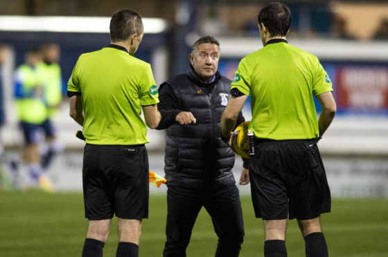 John Robertson argues with the match officials at full-time.