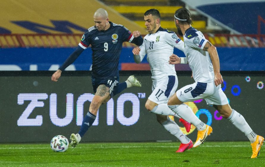 Scotland's Lyndon Dykes (left) holds off Serbia's Filip Kostic.