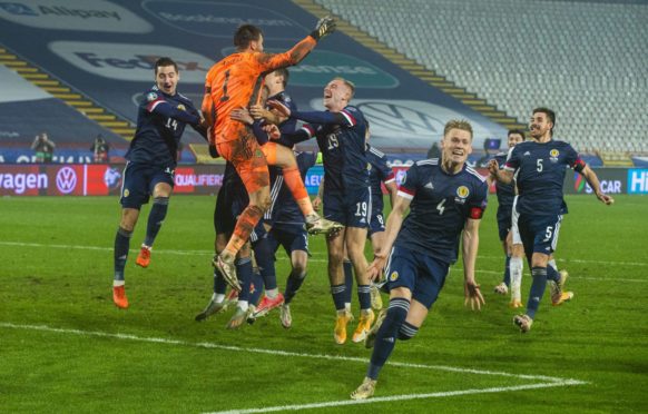 David Marshall is held aloft after saving Aleksandar Mitrovic's penalty.