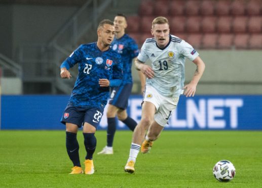 Scotland's Oli McBurnie (R) closes down Slovakia's Stanislav Lobotsky.