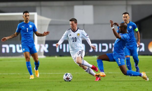 Callum McGregor drives forward against the Israel defence.