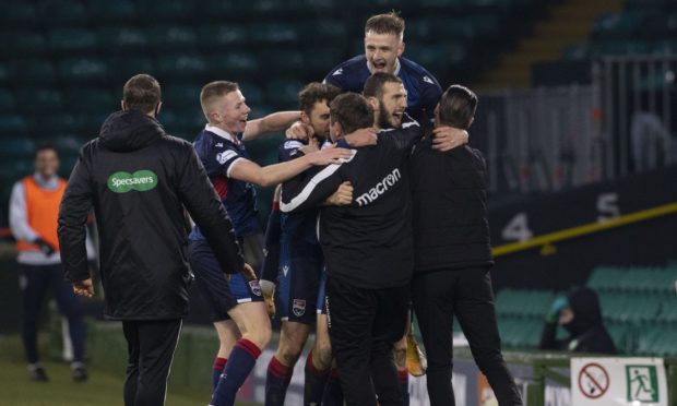 Ross County players celebrate after winning against Celtic at Parkhead.