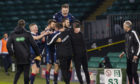 Ross County players and staff celebrate the victory at Parkhead.