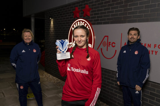 Bayley Hutchison with the SWPL player of the month award for October. Pictured with Aberdeen FC Women coaches Emma Hunter and Stuart Bathgate.