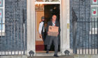 Prime Minister Boris Johnson's top aide Dominic Cummings leaves 10 Downing Street, London, with a box.