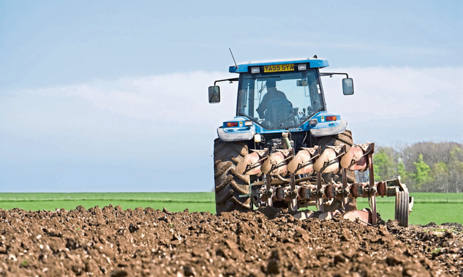 Tractor ploughing field