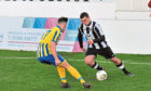Scott Barbour, of Fraserburgh, takes on Inverurie Locos' Thomas Reid in an Aberdenshire Cup clash last week.
Picture by Paul Glendell