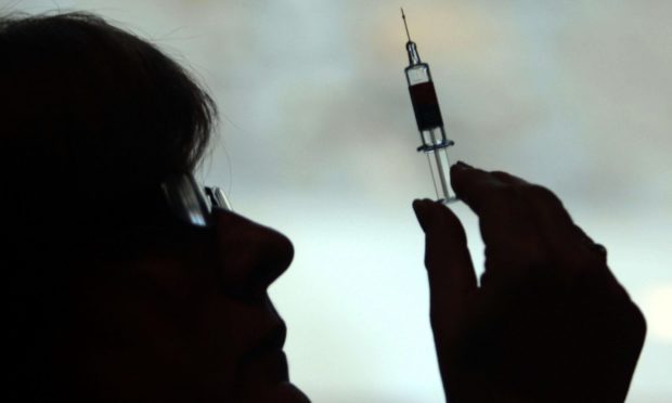 A nurse preparing to give a patient a vaccine.