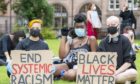 Protesters gather near the Melville Monument in St Andrews Square, Edinburgh, for the "Justice For Slaves" demonstration organised by Black Lives Matter Scotland.