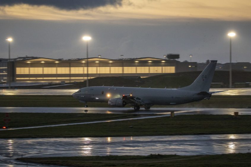 P-8A Poseidon ZP804 lands on the runway at RAF Lossiemouth with the it's new hangar in the background.