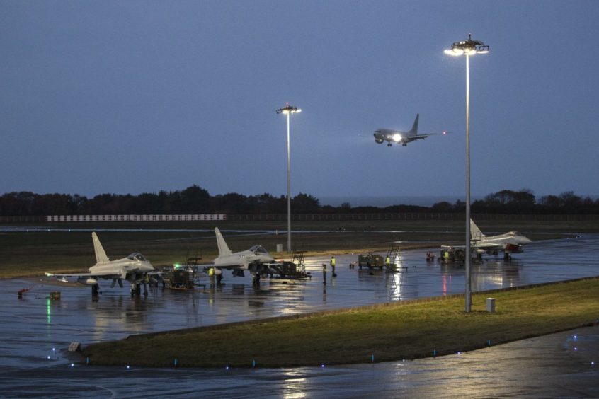 Typhoons taxi back in from a sortie as P-8A Spirit of Reykjavik Poseidon arrives at its new home at RAF Lossiemouth.