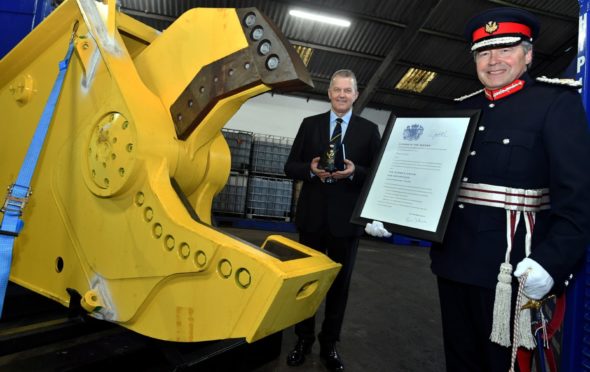 Hiretech CEO Andy Buchan receives the firm's Queen's Award from the Lord-Lieutenant for Aberdeenshire Sandy Manson.