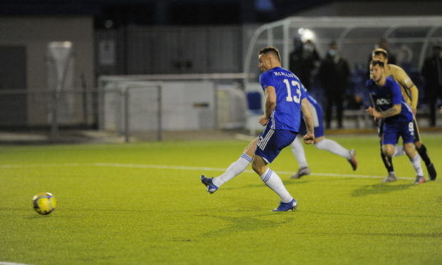 Rory McAllister scores from the spot.